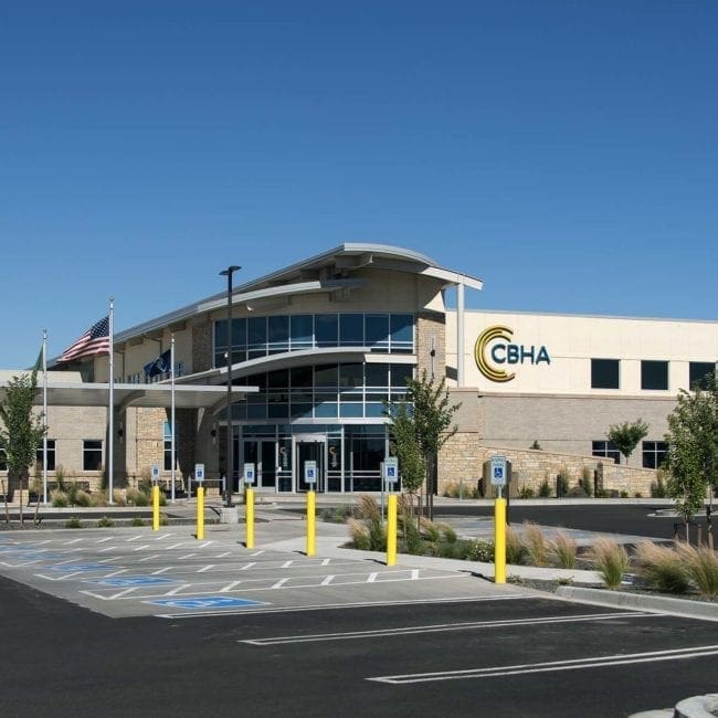 Front of building with parking lot and tree