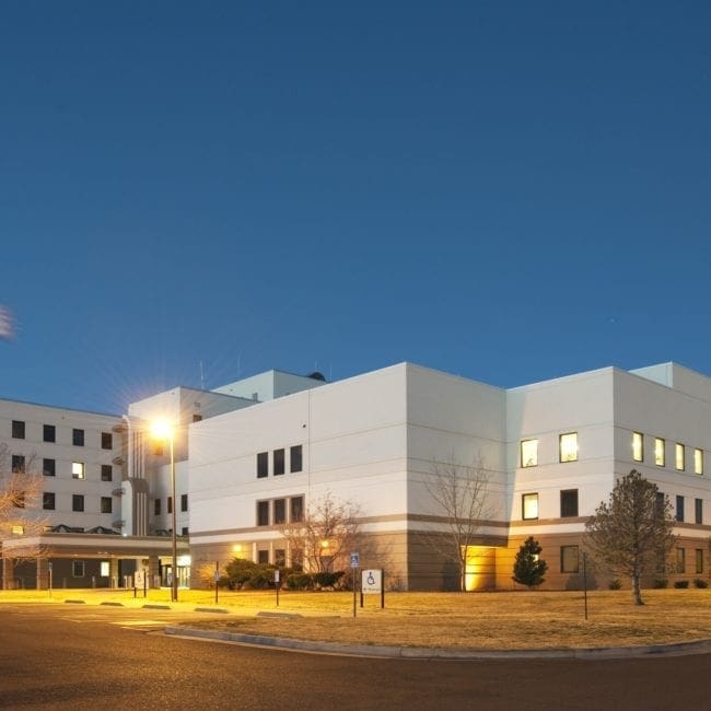 Large white building with grass