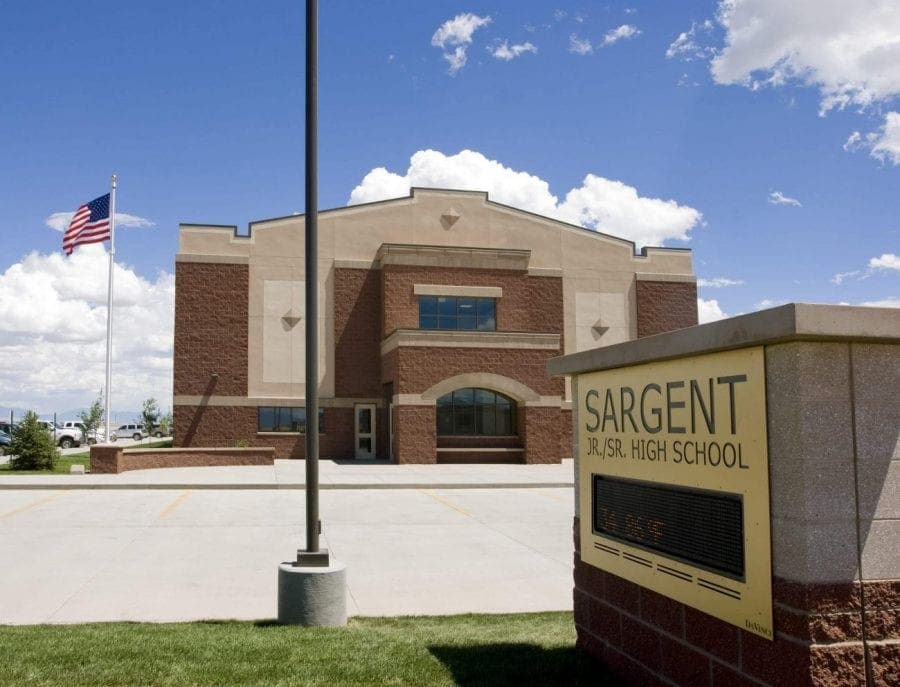 Front of school with sign