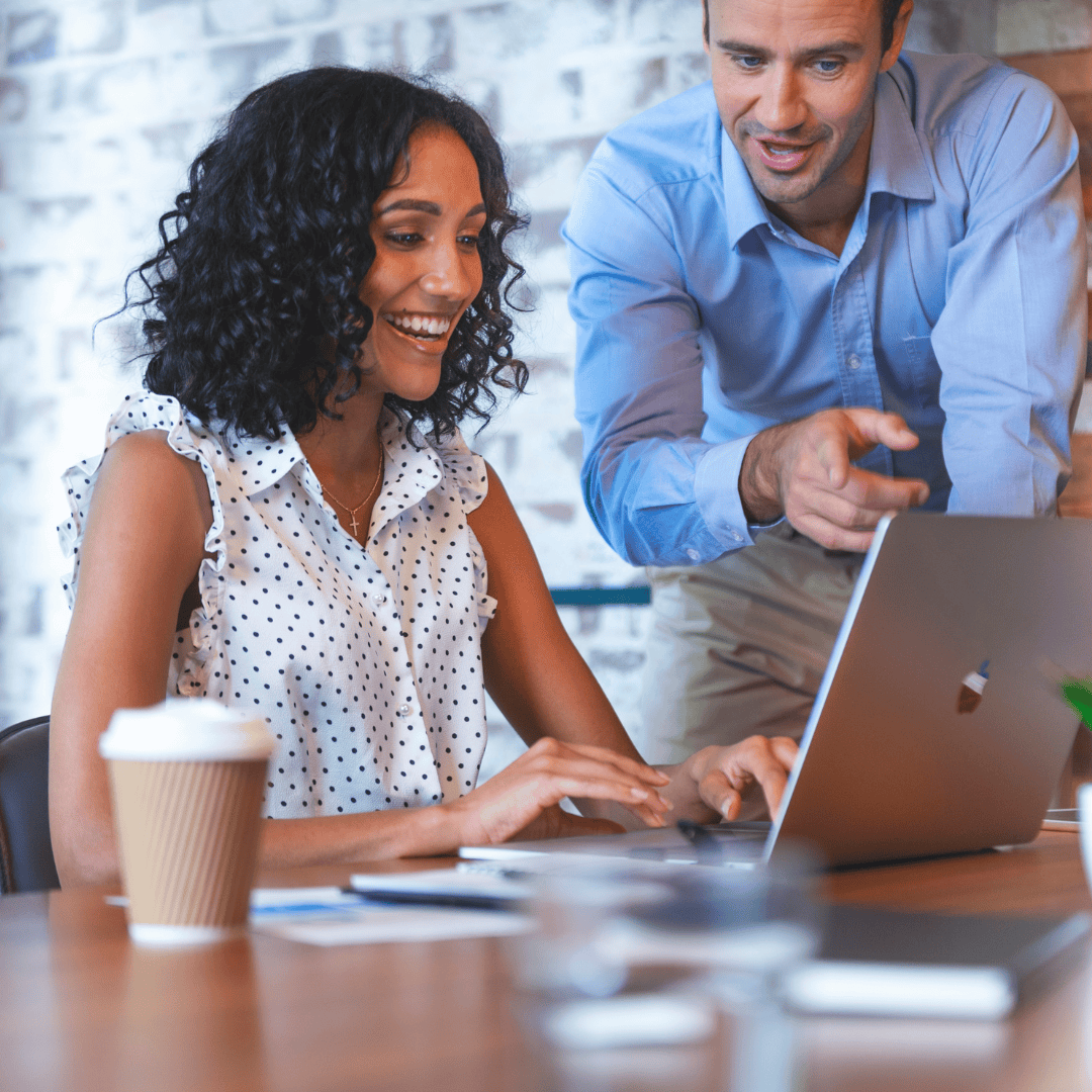 woman and man looking at laptop